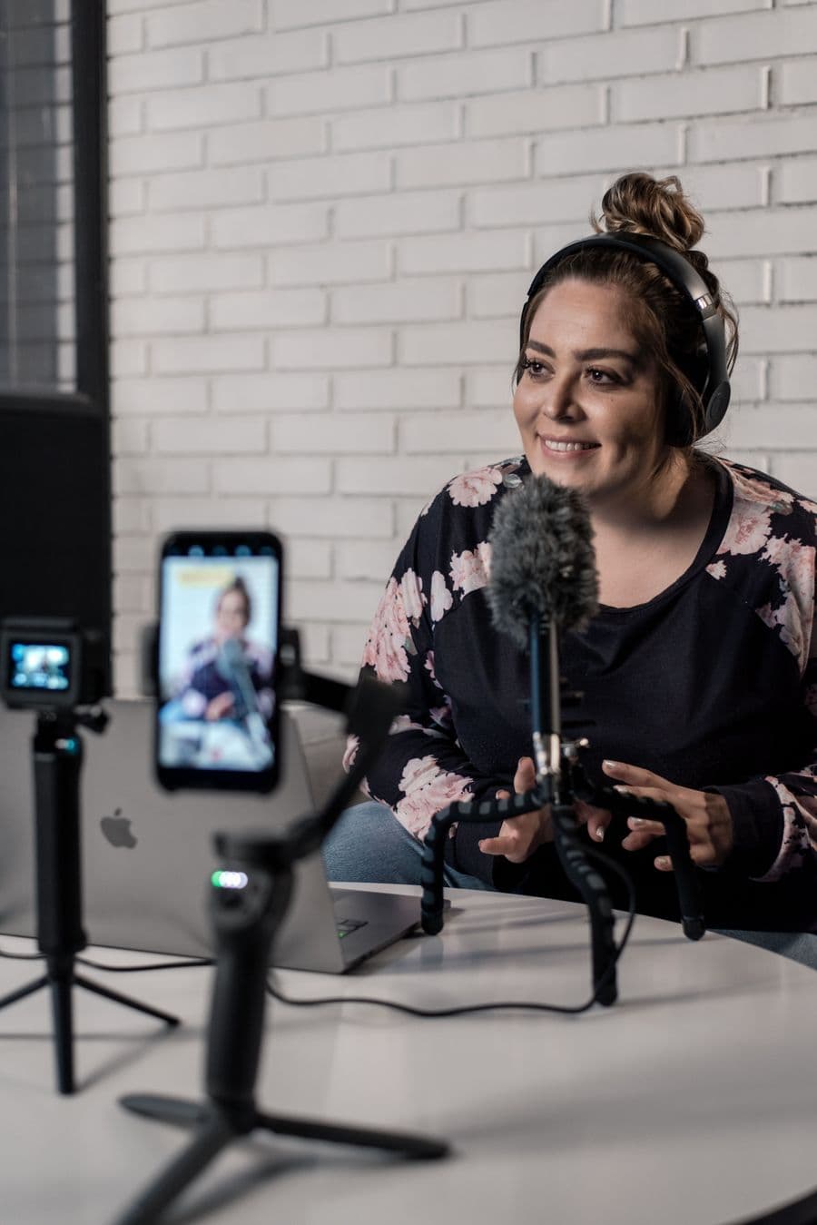 Podcast creator recording with microphone and headphones