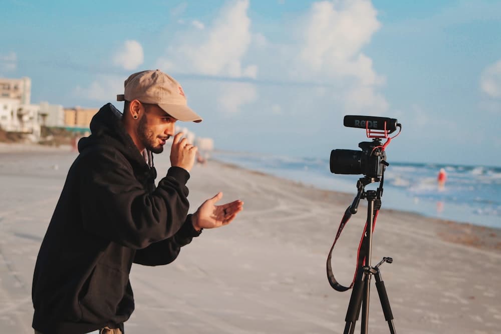A creator filming a video on the beach